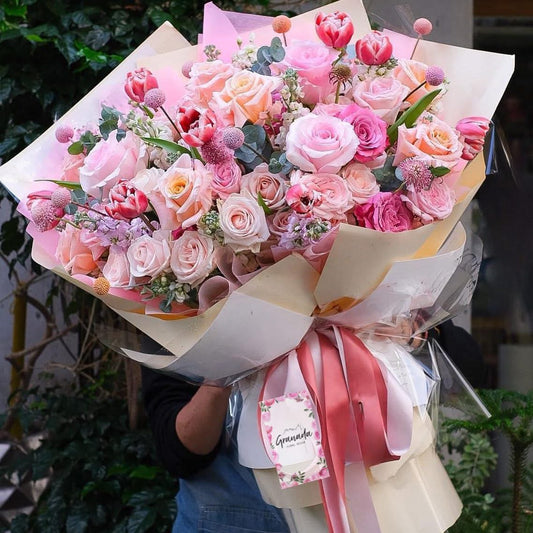 Luxury pink garden bouquet with roses, tulips and pastel seasonal flowers by Granada Floral San Diego.

