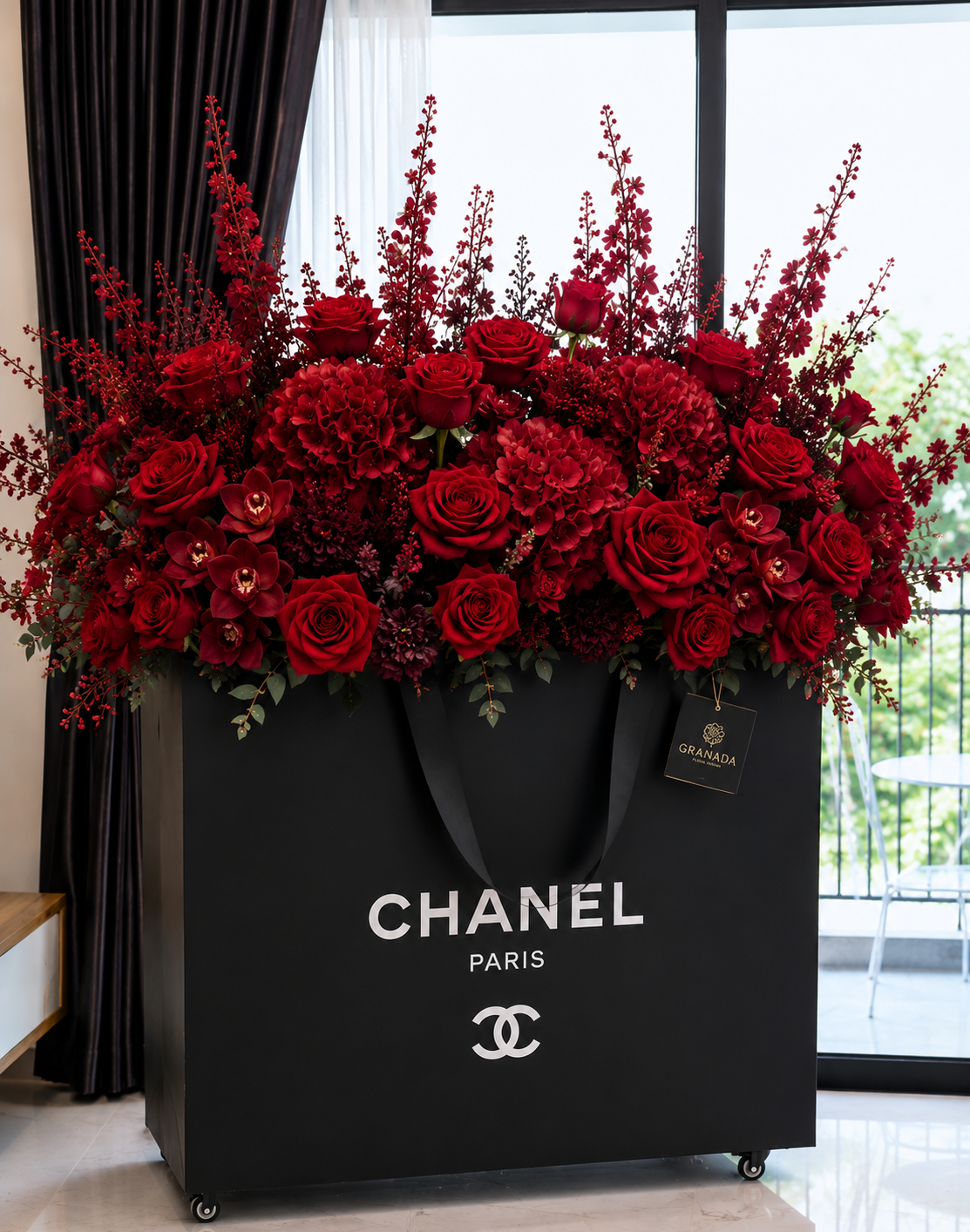 Luxury Chanel-inspired black couture bag with dramatic all-red roses and orchids – Granada Floral Design San Diego