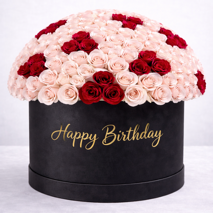 Black birthday gift box with pink and red roses on a white background