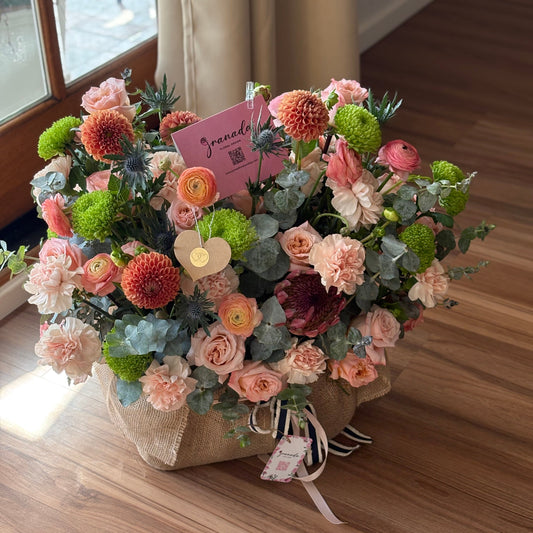 Bouquet of flowers on a wooden floor with a window in the background