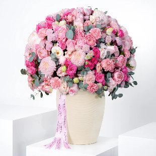 Large bouquet of pink and green flowers in a pot on a white background