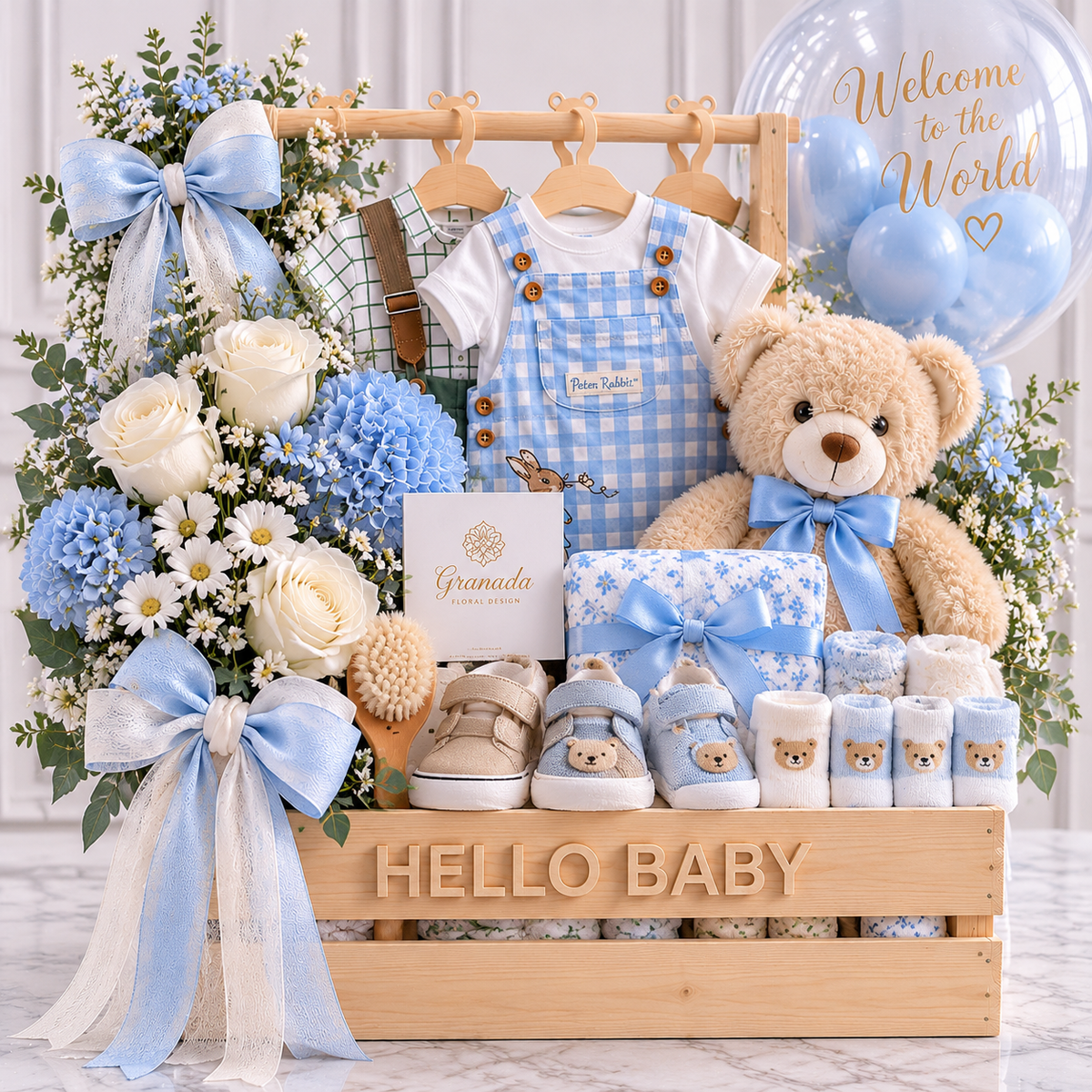 Hello Baby blue gift crate with clothes, shoes, socks, teddy bear, brush, towel, fresh flowers and balloon