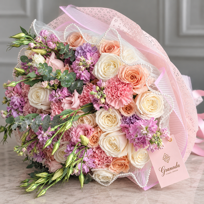 Pastel pink lavender and ivory round bouquet in pink wrapping by Granada Floral Design San Diego