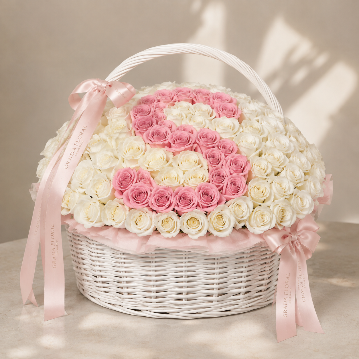 100 white roses with pink initial in white wicker basket – Granada Floral San Diego