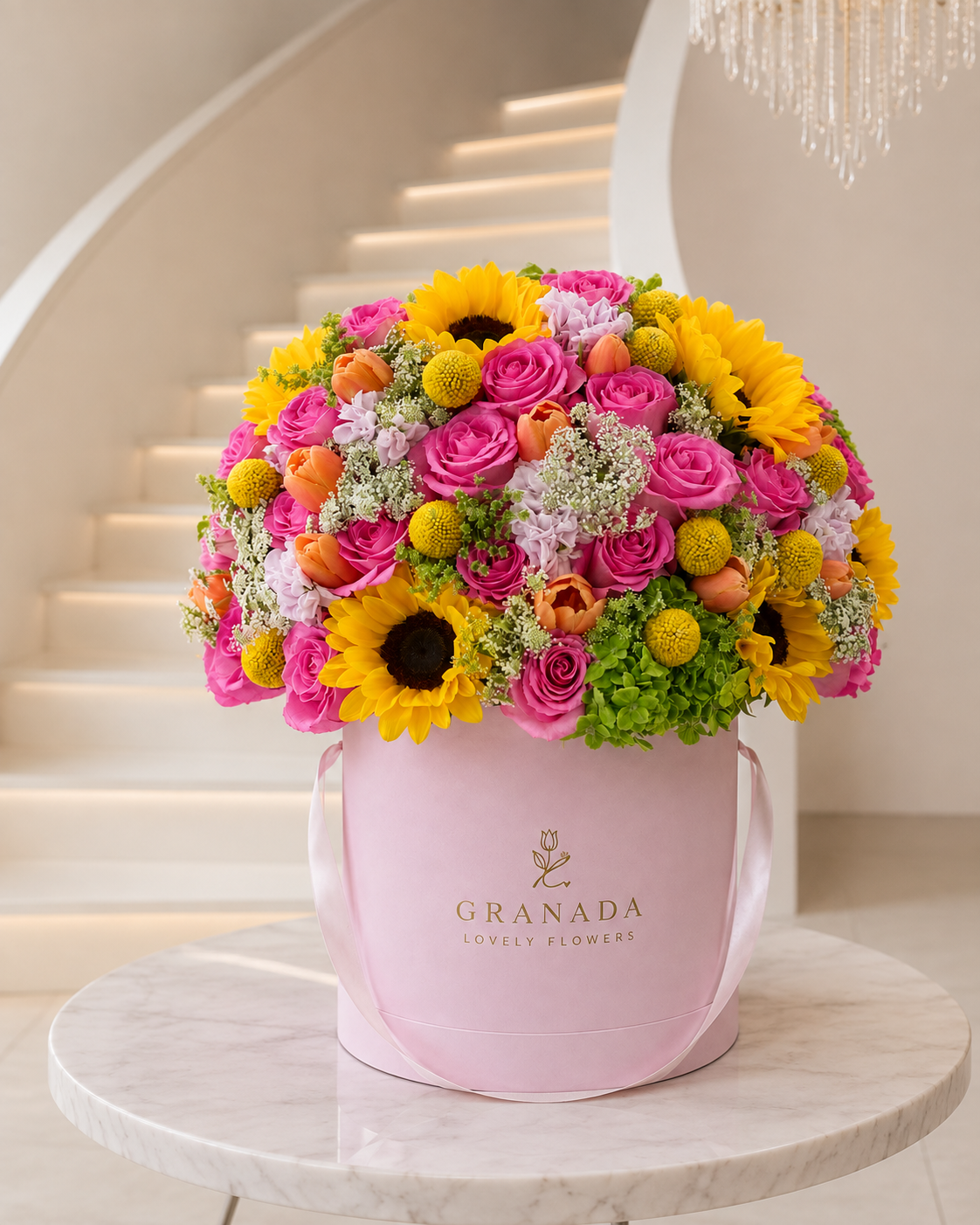 Medium vibrant flower box with pink roses, sunflowers and seasonal blooms in pink Granada hatbox